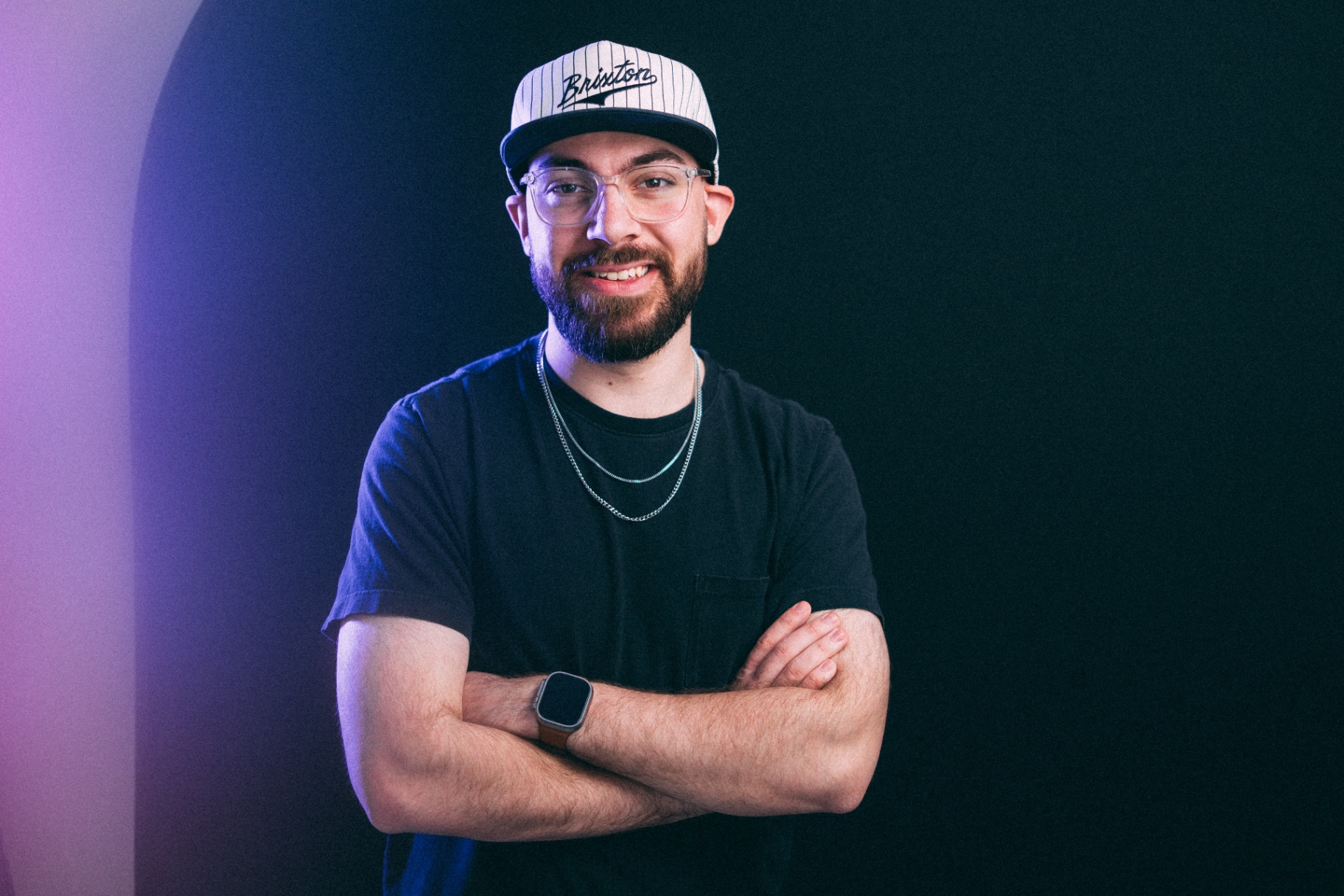 Christian smiling, arms crossed